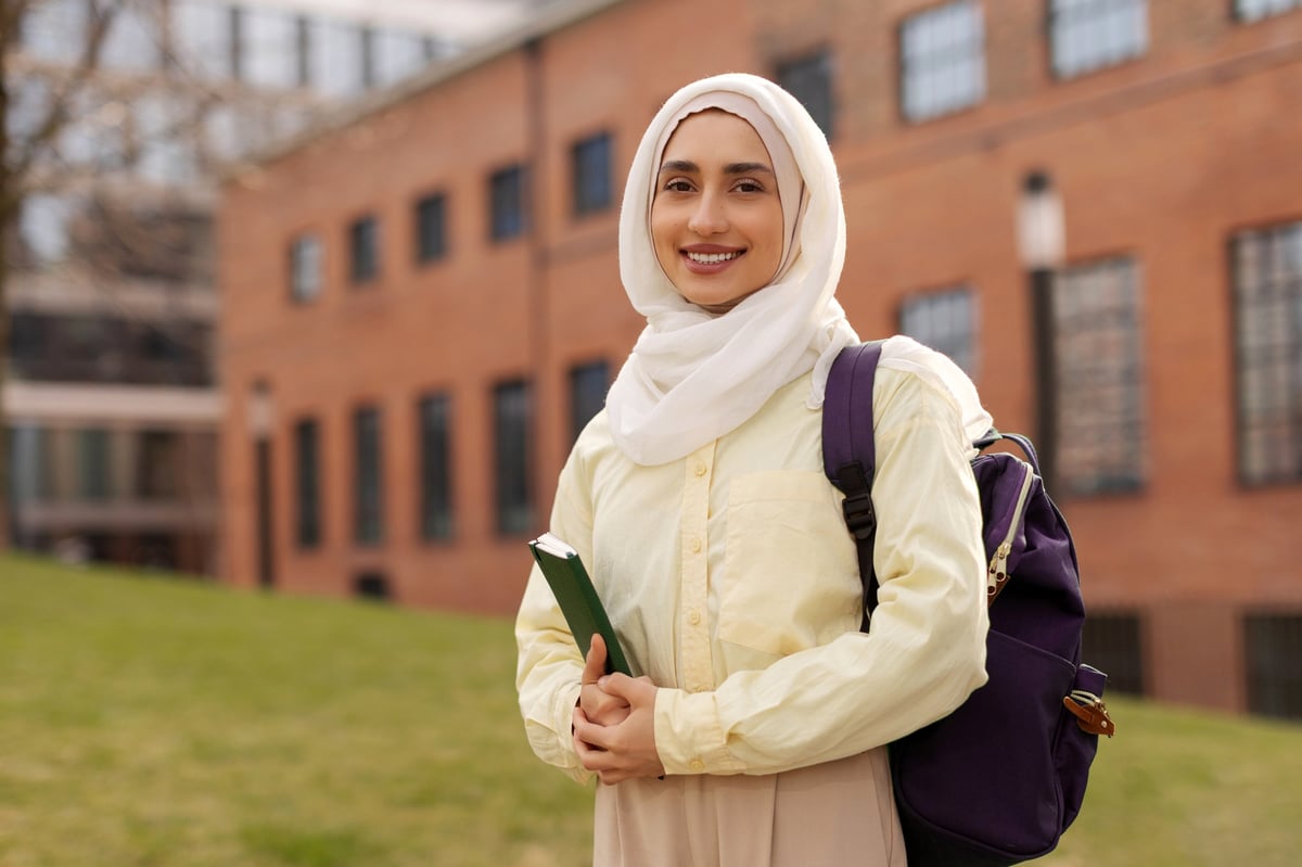 A Muslim businesswoman helping a client in a modern office